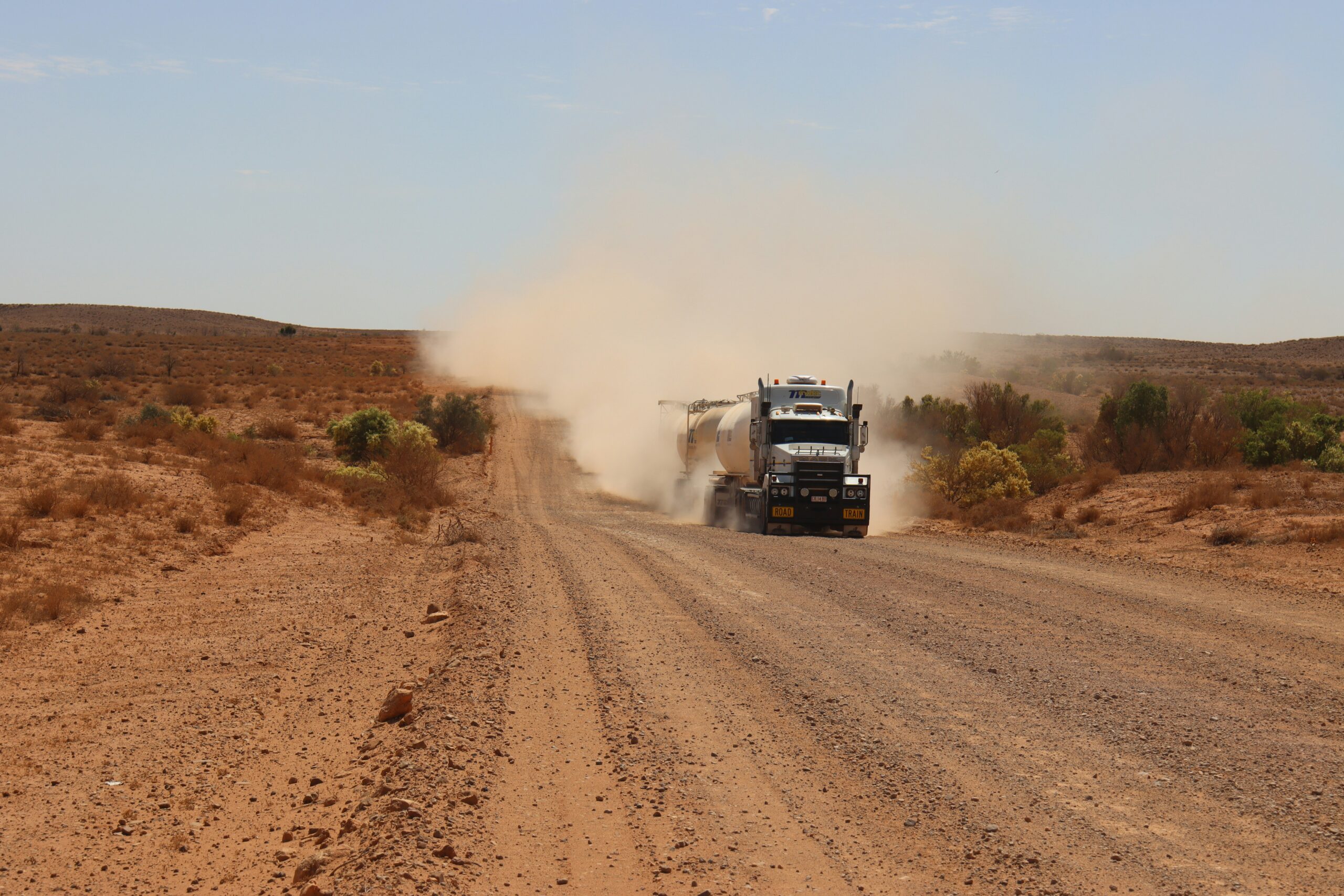 Truck driving along unsealed rural road